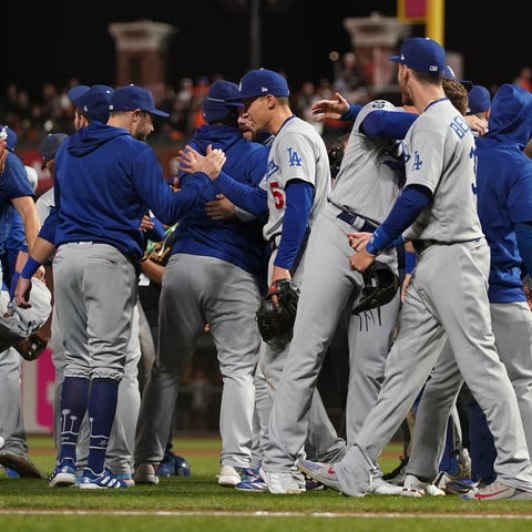 The Dodgers celebrate after defeating the Giants i