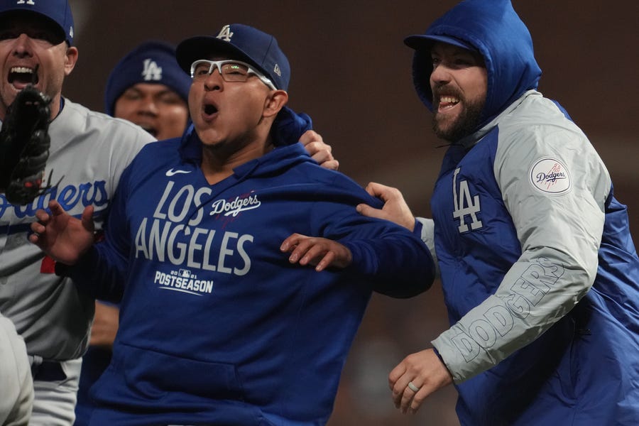 NLDS Game 5: Dodgers starting pitcher Julio Urias (middle) celebrates with teammates.