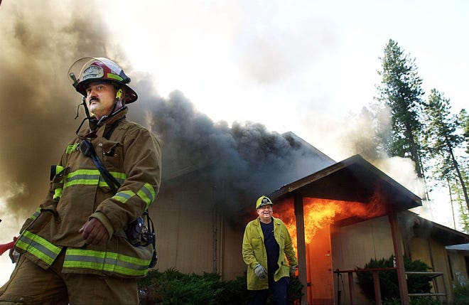 Firefighters from northern Idaho and eastern Washington participate in fire training on July 11, 2001, climaxing with the destruction of the church structure at the former Aryan Nations compound in Hayden, Idaho. The only other structure then remaining at the compound was the former residence of Aryan Nations leader Richard Butler, which also was to be used for firefighter training.