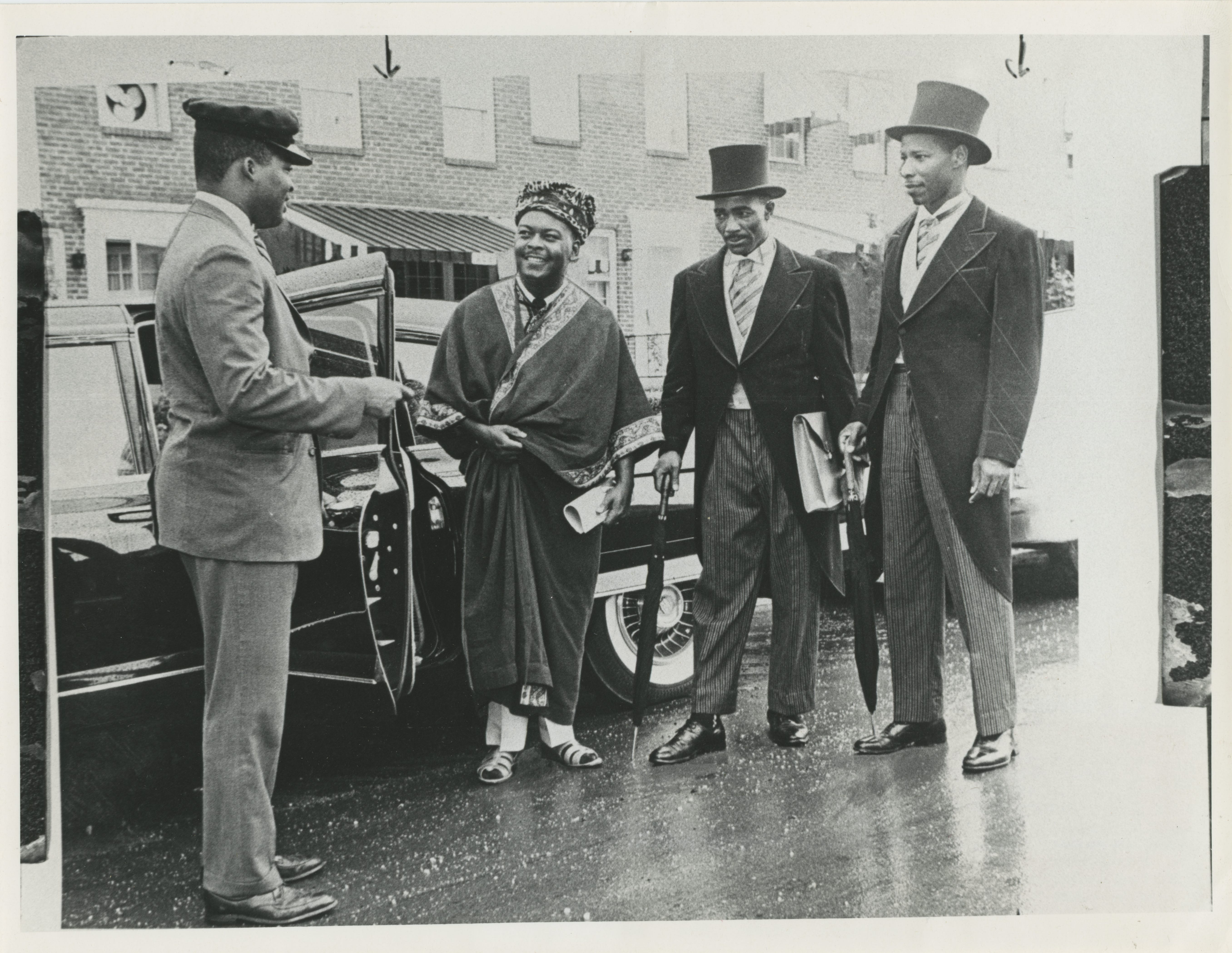 Dressed as African diplomats, reporters Herbert Magrum, from left, George Collins and Rufus Wells prepare to head out on assignment in their chauffeured limousine in August 1961. Writers for an Afro newspaper, they were testing whether owners of segregated restaurants along Maryland's Route 40 corridor would serve "African diplomats."
