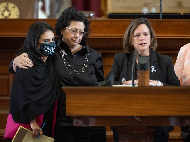 State Rep. Ana-Maria Ramos, D-Richardson, left, hugs Rep. Celia Israel, D- Austin, while Rep. Ann Johnson, D-Houston, speaks against House Bill 25, which limits the participation of transgender athletes in public school sports, in the House Chamber on Thursday.