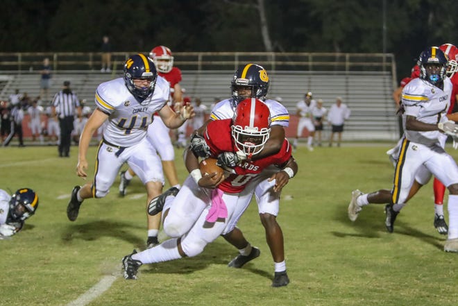 Jacksonville's Damon June is brought down during the Cardinals' 42-21 loss to D.H. Conley on Friday.