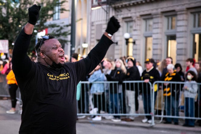 Bruce Teague, mayor of Iowa City, cheers during the University of Iowa Homecoming Parade, Friday, Oct. 15, 2021, in Iowa City, Iowa.