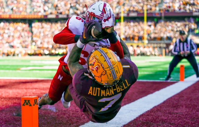 Minnesota wide receiver Chris Autman-Bell (7) catches a touchdown pass against Nebraska cornerback Quinton Newsome (6) defends during their game at Huntington Bank Stadium.
