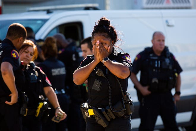 A Harris County Pct. 4 deputy exits the Harris County Institute of Forensic Sciences mourning the death of a deputy who was shot and killed in north Houston, Saturday, Oct. 16, 2021.