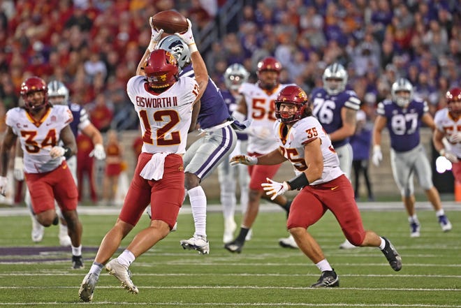 Iowa State defensive back Greg Eisworth II (12) intercepts a pass against Kansas State during the first quarter Saturday night at Bill Snyder Family Stadium..