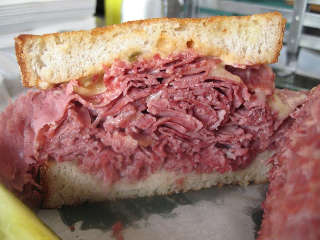 The hot corned beef sandwich on house-baked bread, with swiss, at Noah's Deli in Dearborn.