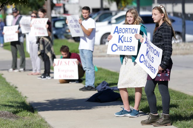 Demonstrators line Sagamore Parkway during an anti-abortion rally organized by Tippecanoe County Right To Life, Sunday, Oct. 17, 2021 in Lafayette.