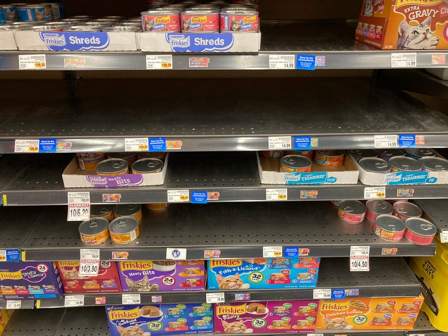 Shelves that normally hold flats of canned cat food sit empty in a King Soopers grocery store in southeast Denver.