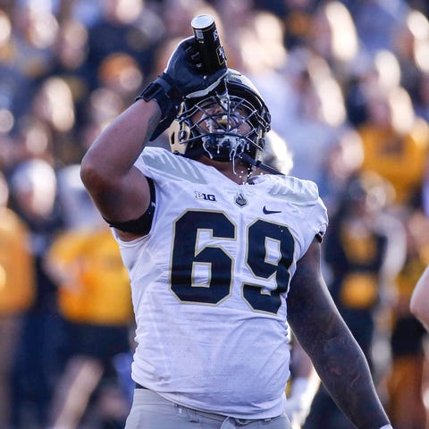 Purdue offensive lineman Greg Long pours a can of 