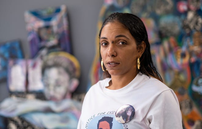 Casey Goodson's mom, Tamala Payne, poses for a photo at the offices of Walton Brown Law with artwork by local artist Richard Duarte Brown in the background.