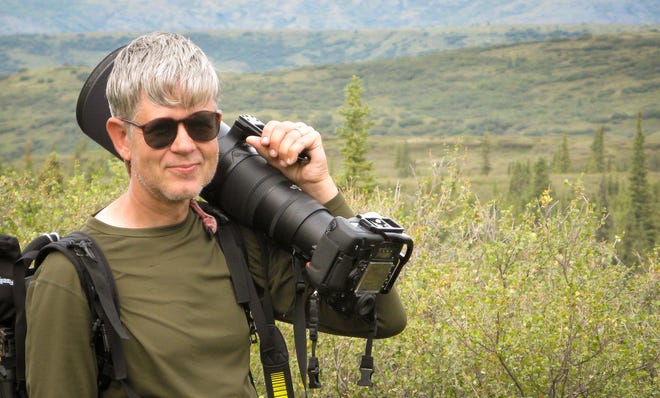Outdoor photojournalist, John L. Dengler, carrying camera equipment while photographing in Denali National Park and Preserve, Alaska.