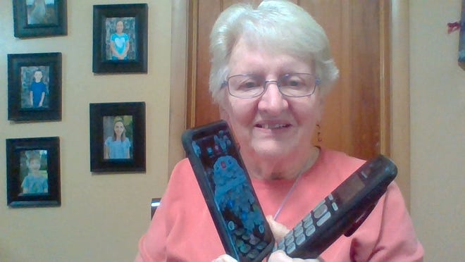 Susan with two phones: one broken and one working, well sort of working.