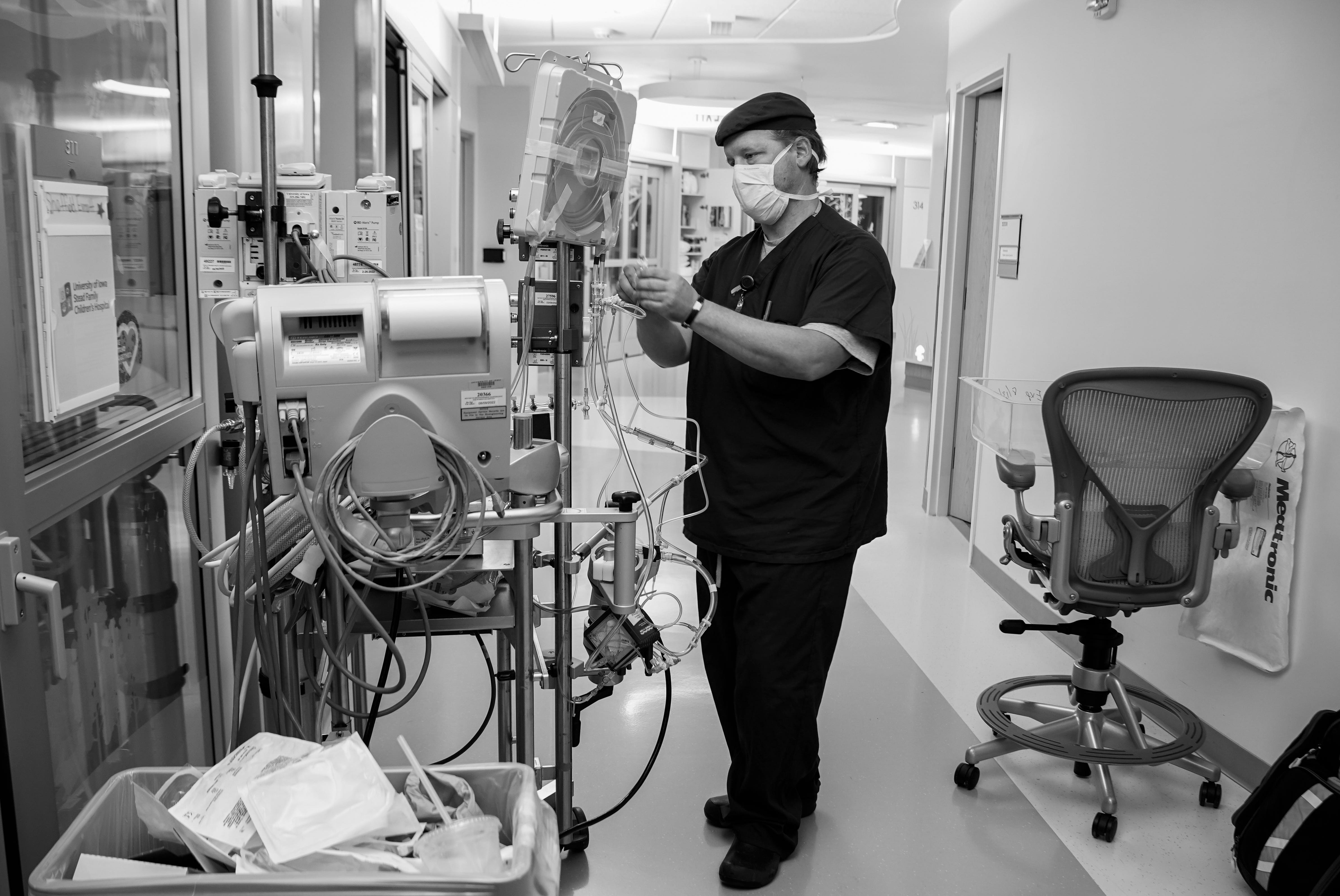 Oct 7, 2021; Iowa City, IA, United States; Veteran nurse and ECMO specialist Mike MacCormick builds an ECMO pump in the hall at University of Iowa Stead Family Children's Hospital Pediatric Intensive Care Unit. MacCormick lost his daughter, Gabriella, to COVID-19 last January and now continues to work as an ECMO specialist with COVID patients. Mandatory Credit: Jessica Koscielniak-USA TODAY