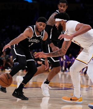 Bruce Brown (1) tries to get around Anthony Davis (3) during a preseason game last week. The Nets and Lakers are projected by USA TODAY Sports to meet in the Finals.