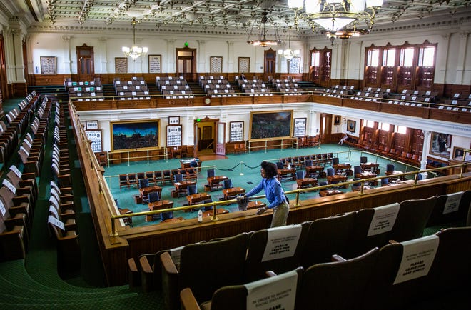 Capitol staff member Ollie Vaughn polishes the railings in the empty Texas Senate chamber on Tuesday. The Legislature adjourned its third special session this year early Tuesday morning.