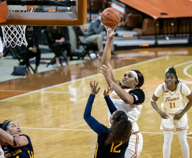 Texas center Lauren Ebo shoots over West Virginia's Esmery Martinez last year at the Erwin Center. The Mountaineers swept both games against the Longhorns last season.
