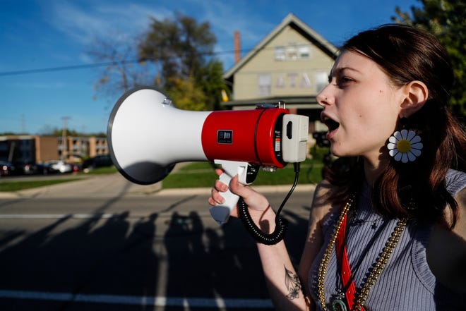 EMU freshmen Lynn Green speaks outside of fraternity Delta Tau Delta during a protest against the fraternities in the center of a sexual assault report in Ypsilanti on Oct. 19, 2021.