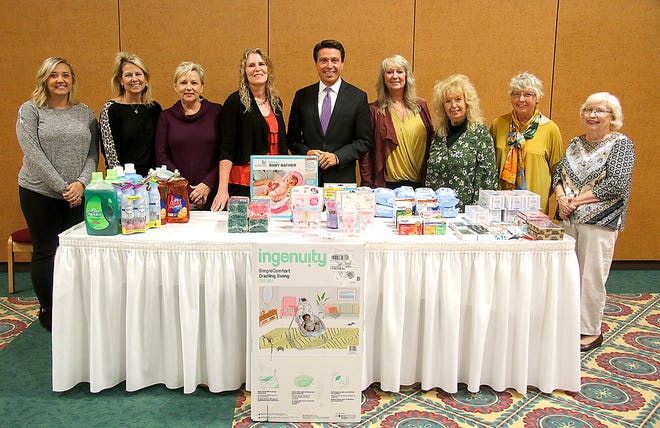 Kelly VanDriest, left, and Rebecca Jentes, second from left, of Safe Haven pose with Mayor Matt Miller along with Ashland BPW members (from left) Kathy Norris, Teresa Clark Chamberlain, Lorell Kline, Majorie Patterson, Sarah Hawthorne and Karen McCready with the items donated to Safe Haven at their National Business Women's Week meeting Monday, Oct. 18, 2021 at Myers Convocation Center.