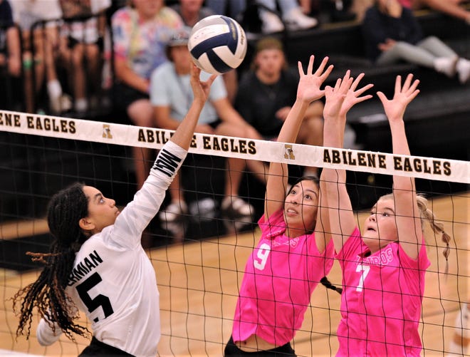 Abilene High's Isa Escobedo (9) and Gentri Anderson (7) defend at the net as Odessa Permian's Cianna Harris (5) hits the ball.