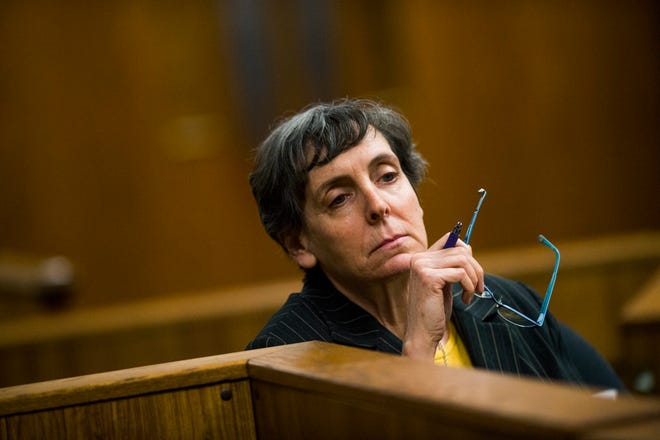 In this Feb. 5, 2018, file photo, defendant Liane Shekter Smith listens during a preliminary examination in the cases of four defendants, all former or current officials from the Michigan Department of Environmental Quality, in Flint, Mich. Shekter Smith, the only Michigan official fired in the Flint water disaster, was likely a "public scapegoat" who lost her job because of politics, an arbitrator said in ordering $191,880 in back pay and other compensation.