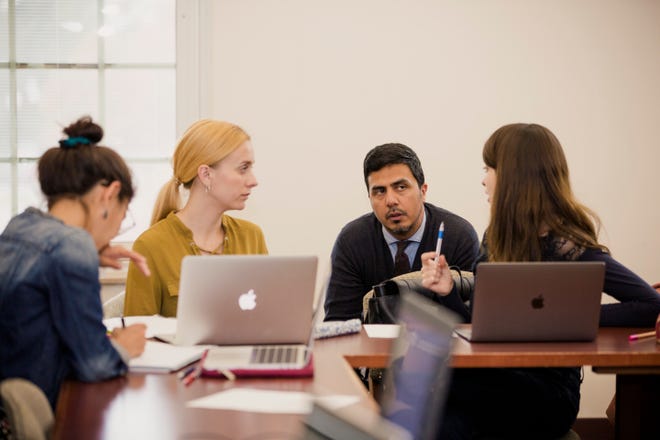 Ahmed Khanani, an assistant professor of politics at Earlham College, listens during a class.