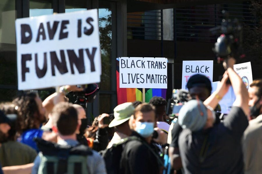 People rally in support of the Netflix transgender walkout and others in support of comedy and free speech, on October 20, 2021 in Los Angeles, California - Netflix bosses braced for an employee walkout and rally in Los Angeles on October 20, 2021 as anger swelled over a new Dave Chappelle comedy special that activists say is harmful to the transgender community.