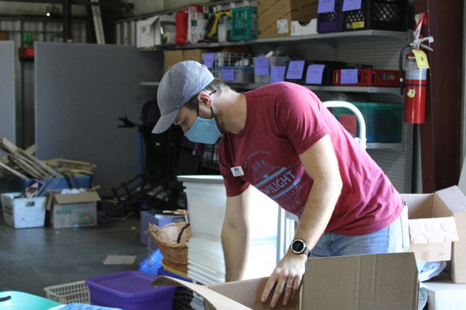 Books for Keeps executive director Justin Bray packs books for the community book fair.