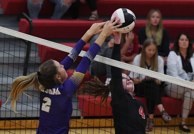 Roland-Story setter Madison Geise tries to get past a block attempt by Nevada middle blocker Lily Goos during the fourth set of the 3A regional semifinal match between the 12th-ranked Norse and Cubs Oct. 20 at the Norsemen Gym in Story City. Nevada won in four sets.