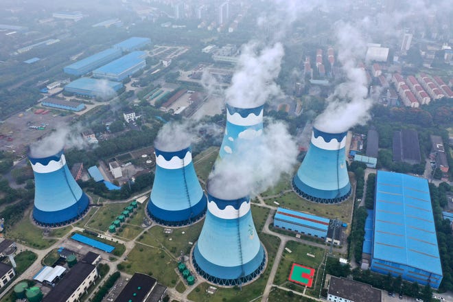 Steam billows out of the cooling towers at a coal-fired power station in Nanjing in east China's Jiangsu province.