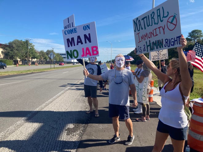 Protesters of President Joe Biden's COVID-19 vaccine mandate stand across from Northrop Grumman's St. Johns County location on U.S. 1 North on Oct. 21, 2021.