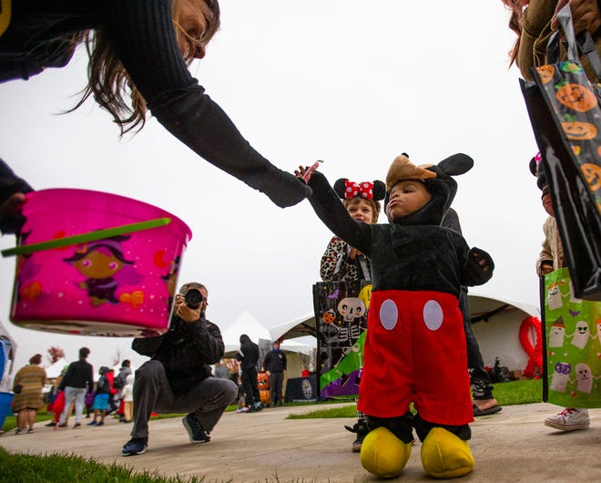 Angelica Bueno-Cruz hands out candy to Miles Story, 1, during the 525 Foundation's "Say Boo to Drugs" event Thursday at Howard Park in South Bend.