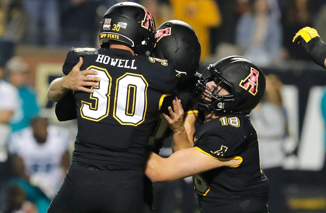 Oct 20, 2021; Boone, North Carolina, USA; Appalachian State Mountaineers place kicker Chandler Staton (middle) is hoisted up by punter Clayton Howell (30) and tight end Mike Evans (18) following a last second game winning field goal against the Coastal Carolina Chanticleers at Kidd Brewer Stadium. Mandatory Credit: Reinhold Matay-USA TODAY Sports