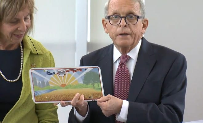 Ohio Gov. Mike DeWine unveiled a new Ohio license plate on Thursday.