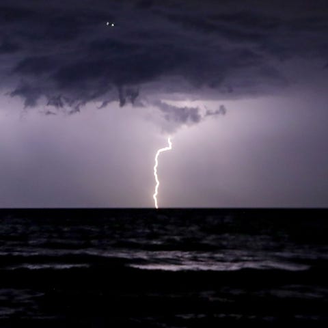 Lightning strikes over Lake Michigan off the shore