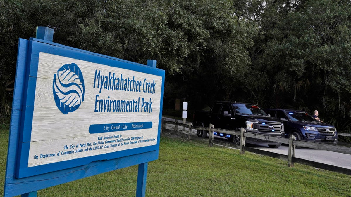 North Port, Fla., police officer block the entrance to the Myakkahatchee Creek Environmental Park Wednesday, Oct. 20, 2021, in North Port, Fla. Items believed to belong to Brian Laundrie and potential human remains were found in a Florida wilderness park during a search for clues in the slaying of Gabby Petito .