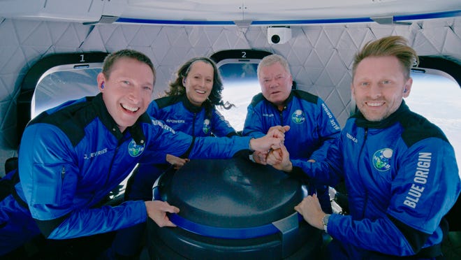 This photo provided by Blue Origin shows Blue Origin's New Shepard rocket space passengers from left, Glen de Vries, Audrey Powers, William Shatner, and Chris Boshuizen pose inside the capsule on Wednesday, Oct. 13, 2021.  The “Star Trek” actor and three fellow passengers hurtled to an altitude of 66.5 miles (107 kilometers) over the West Texas desert in the fully automated capsule, then safely parachuted back to Earth in a flight that lasted just over 10 minutes.  (Blue Origin via AP)