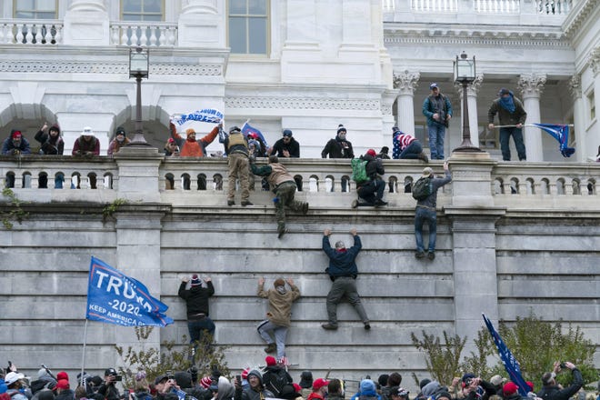 Violent insurrectionists loyal to President Donald Trump scale the west wall of the U.S. Capitol in Washington on Jan. 6.  [AP Photo/Jose Luis Magana, File]