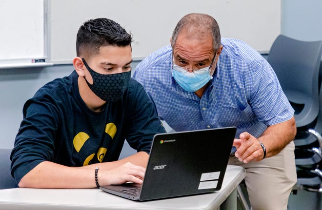 Spanish teacher William Font works with a student at Santa Fe South High School in Oklahoma City on Aug. 12, 2020.