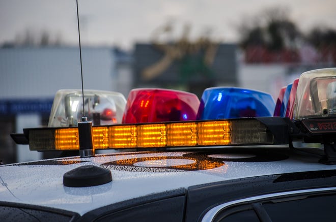 Close-up shot of lights on a police cruiser with a blurred background and dim lighting.