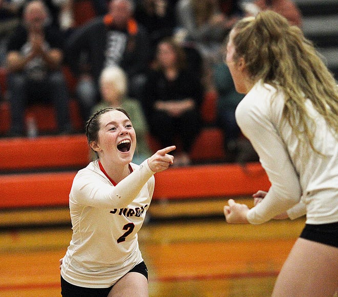 Harlie Blum of Sturgis points in excitement to senior Juliette Schroeder, who assisted on a kill Thursday night.