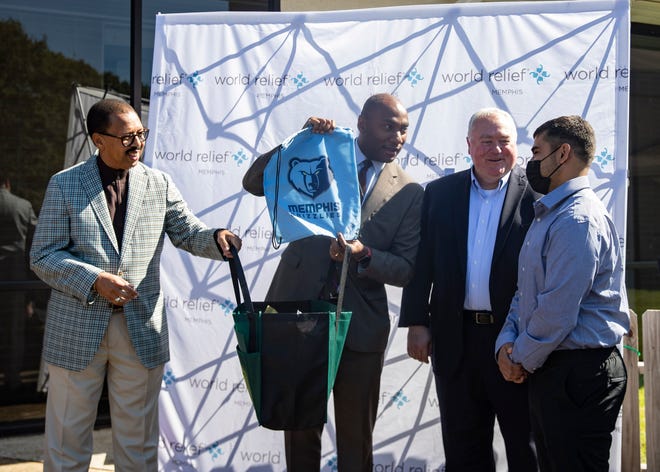 Chairman Willie Brooks, from left, Shelby County Mayor Lee Harris, Commissioner Mark Billingsley takes part in World Relief welcoming Afghan refugee Basir Akrami to Memphis on Friday, Oct. 22, 2021.