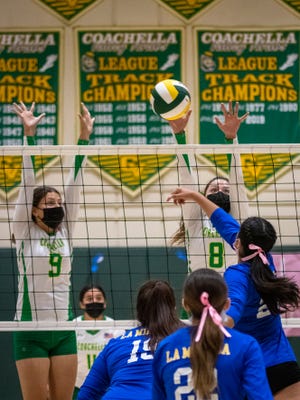 Coachella Valley High School volleyball's Angie Valencia (9) and Melanie Hernandez (8) play defense against La Mirada during the Arabs' 3-1 CIF-SS playoff win Thursday.