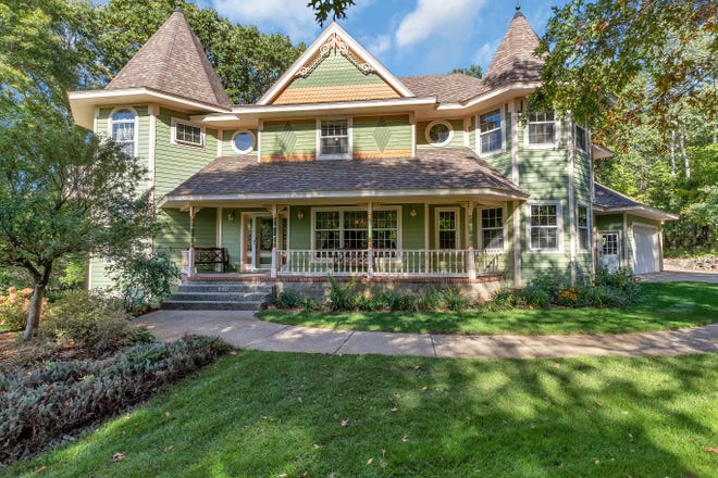 This custom-built Neo-Victorian/Queen Anne home sits on a more than two-acre private, wooded lot.