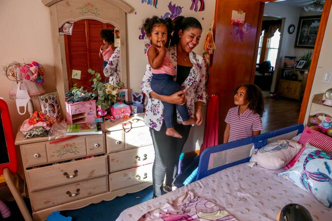Ana Gomez, of Woonsocket, with daughters Lelia and Abigail Herrera. Gomez works as a caregiver while taking online business classes at Community College of Rhode Island.