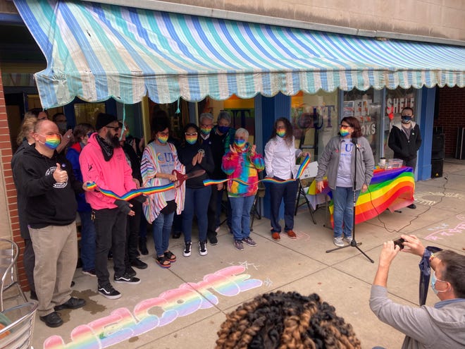 Representatives from Springfield’s Phoenix Center mark the grand opening of its new store, Out on Adams, 413 E. Adams St., in a ribbon-cutting ceremony Saturday during the Old Capitol Farmers Market.