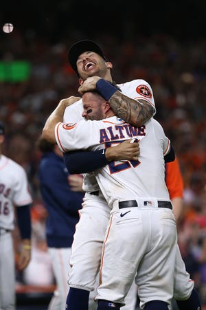 Astros shortstop Carlos Correa celebrates with Jose Altuve after defeating the Red Sox to advance to the World Series.
