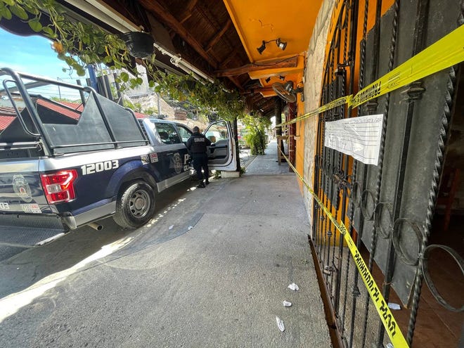 Police security tape covers the exterior of a restaurant the day after a fatal shooting in Tulum, Mexico, Friday, Oct. 22, 2021. The killings threatened Tulum's reputation as a low-key carefree beach town without the crowding and problems of Cancun.