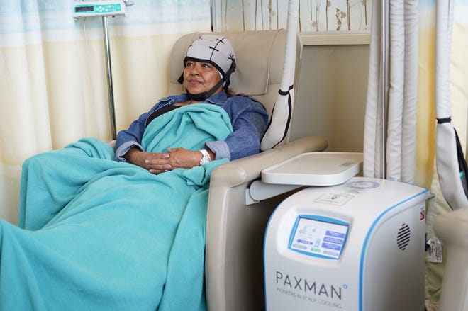 An unidentified woman using the Paxman cooling cap system during chemotherapy. The caps can help prevent hair loss.