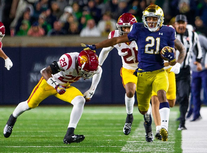 Notre Dame’s Lorenzo Styles (21) tries to get away from USC's Xavion Alford (29) during the Notre Dame vs. USC NCAA football game Saturday, Oct. 23, 2021 at Notre Dame Stadium in South Bend. 
